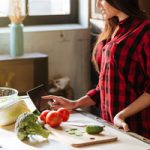 graphicstock-cropped-image-of-woman-in-red-shirt-standing-in-kitchen-with-tablet-computer-and-looking-recipes-side-view_BLIeriD7Ohl_thumb
